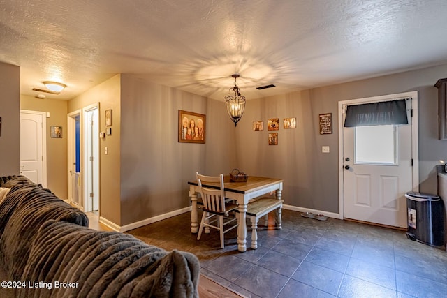 dining area featuring a textured ceiling