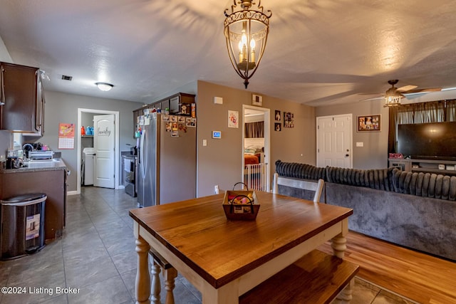 tiled dining space featuring washer / dryer, a textured ceiling, and ceiling fan