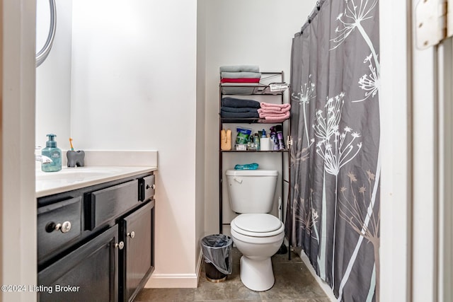 bathroom featuring tile patterned floors, vanity, and toilet