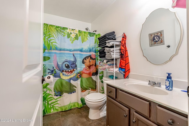 bathroom with vanity, toilet, and walk in shower