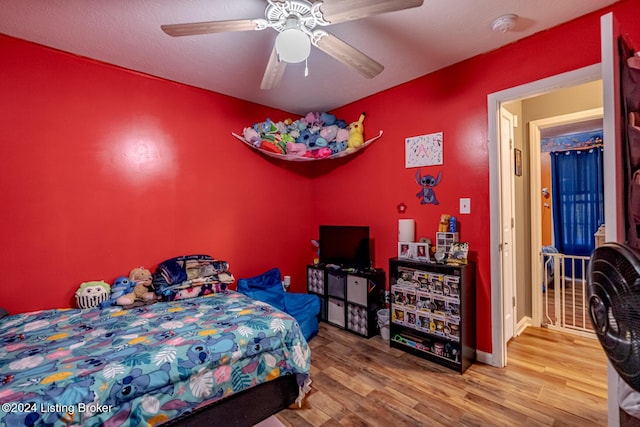 bedroom with ceiling fan and hardwood / wood-style flooring