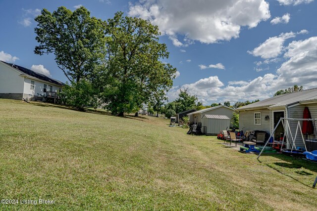 view of yard featuring a patio area and a storage unit