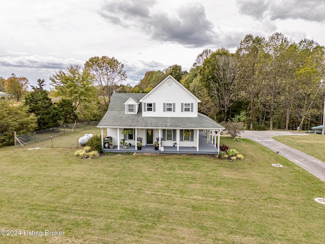 farmhouse-style home featuring covered porch and a front yard