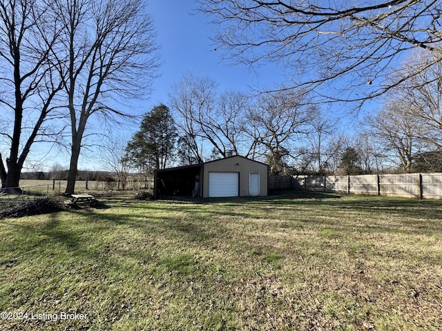 view of yard featuring an outbuilding and a garage