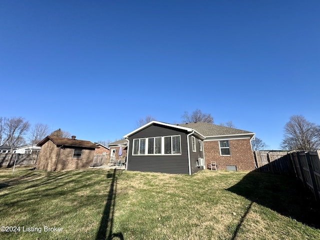 rear view of property featuring a yard