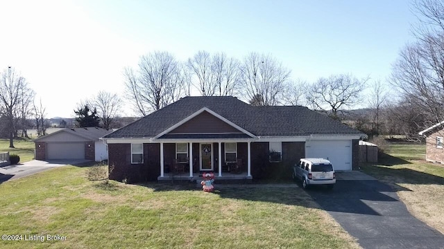 ranch-style house featuring covered porch, a garage, and a front yard