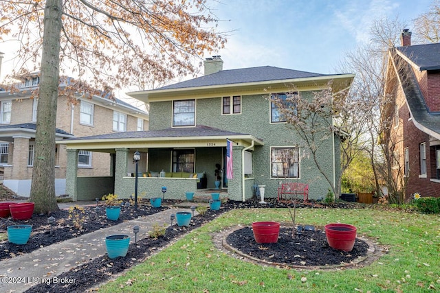 view of property featuring a porch and a front yard