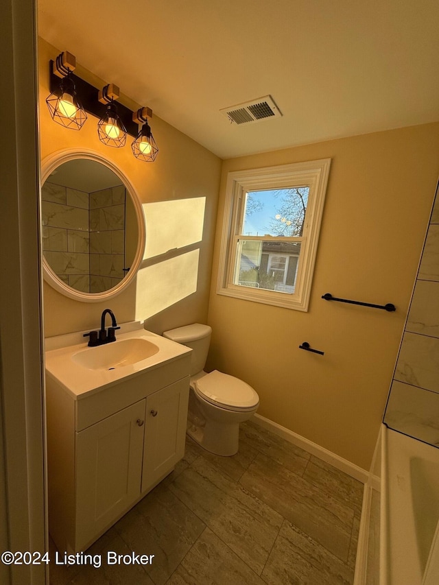 bathroom featuring vanity and toilet