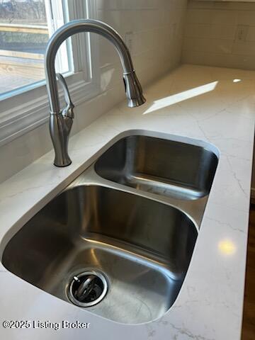 room details with light stone counters and sink