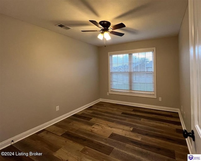 spare room with ceiling fan and dark hardwood / wood-style flooring