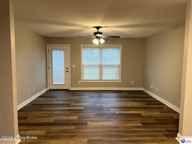 interior space with dark hardwood / wood-style floors, ceiling fan, and a textured ceiling