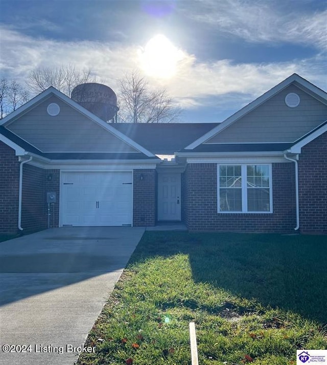 ranch-style home featuring a garage and a front lawn