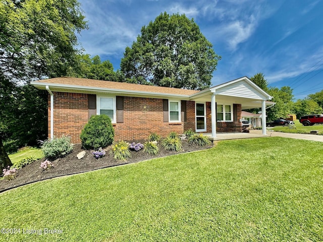 ranch-style home with covered porch and a front yard