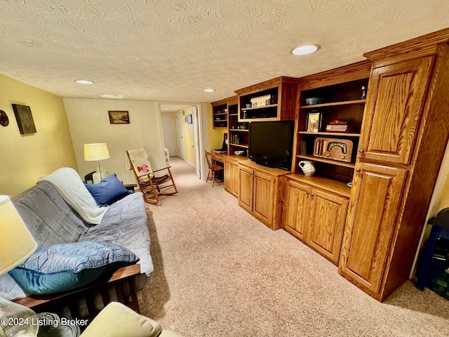 carpeted living room featuring a textured ceiling