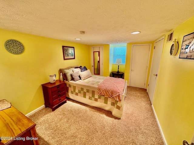 carpeted bedroom with a textured ceiling