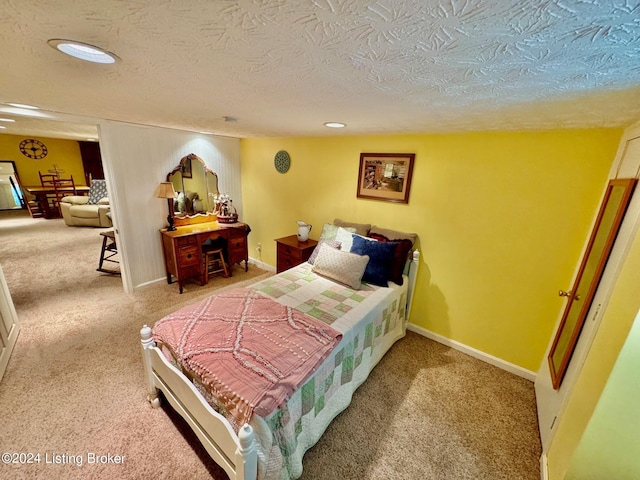 carpeted bedroom featuring a textured ceiling