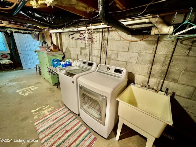 laundry area with washer and clothes dryer and sink