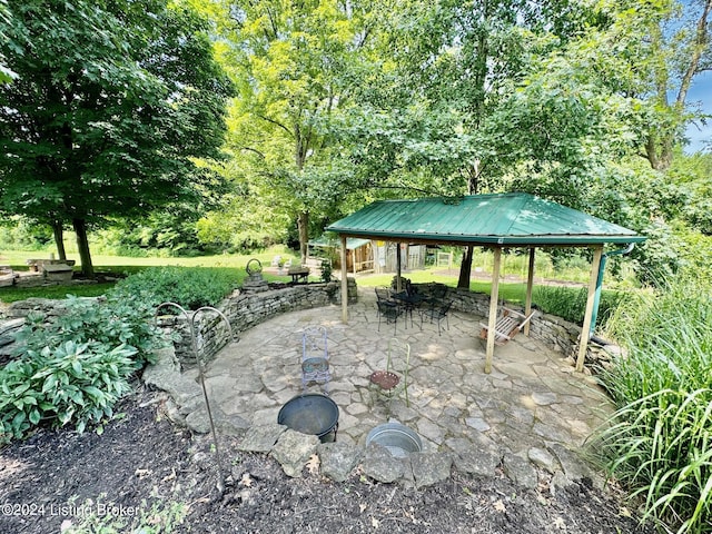 view of patio with a gazebo and an outdoor fire pit