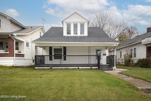 view of front of home with a porch and a front yard