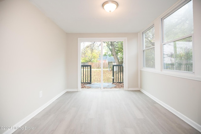 empty room with baseboards and wood finished floors