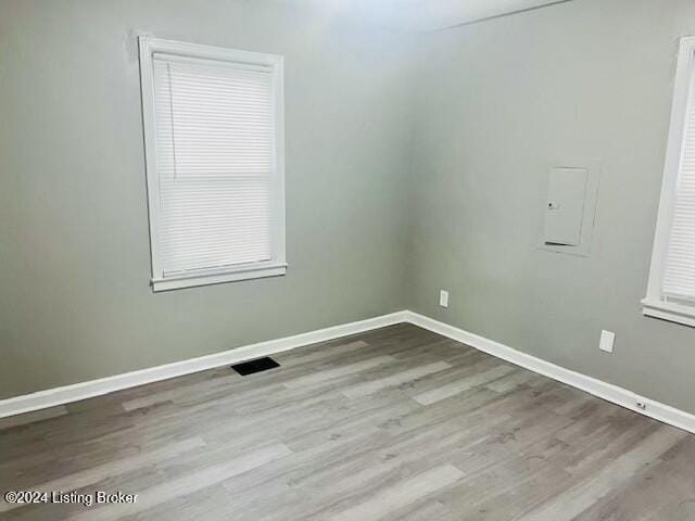 unfurnished room with light hardwood / wood-style floors