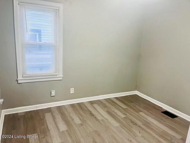 empty room with light hardwood / wood-style flooring