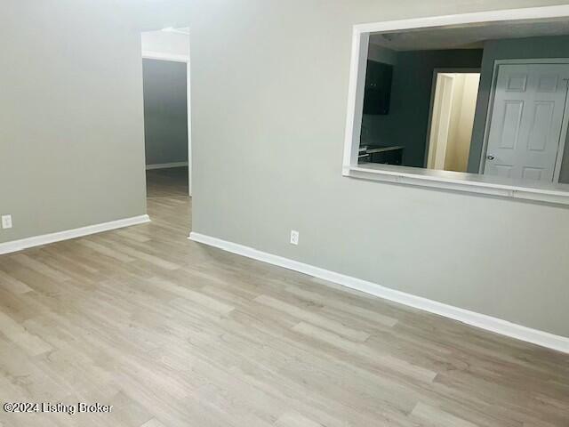 unfurnished room featuring light hardwood / wood-style floors