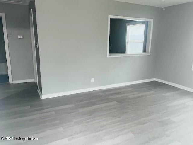 spare room with wood-type flooring