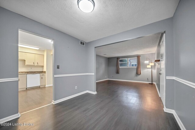 spare room with wood-type flooring and a textured ceiling