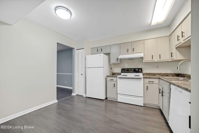 kitchen with wood-type flooring, white appliances, and sink