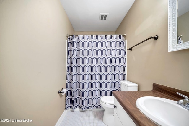 bathroom featuring toilet, vanity, tile patterned floors, and walk in shower