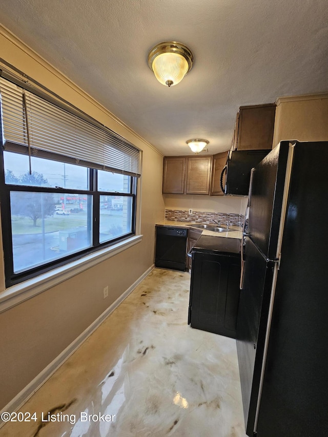 kitchen with a textured ceiling and black appliances