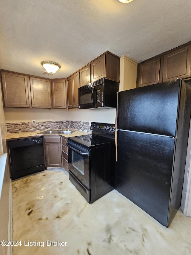 kitchen featuring black appliances, sink, and a textured ceiling