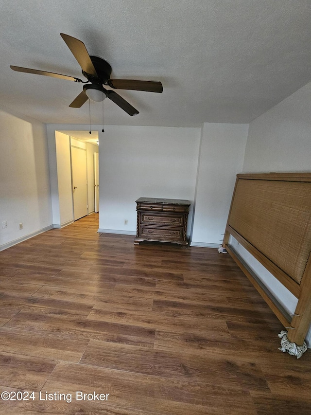 interior space featuring a textured ceiling, dark hardwood / wood-style flooring, and ceiling fan