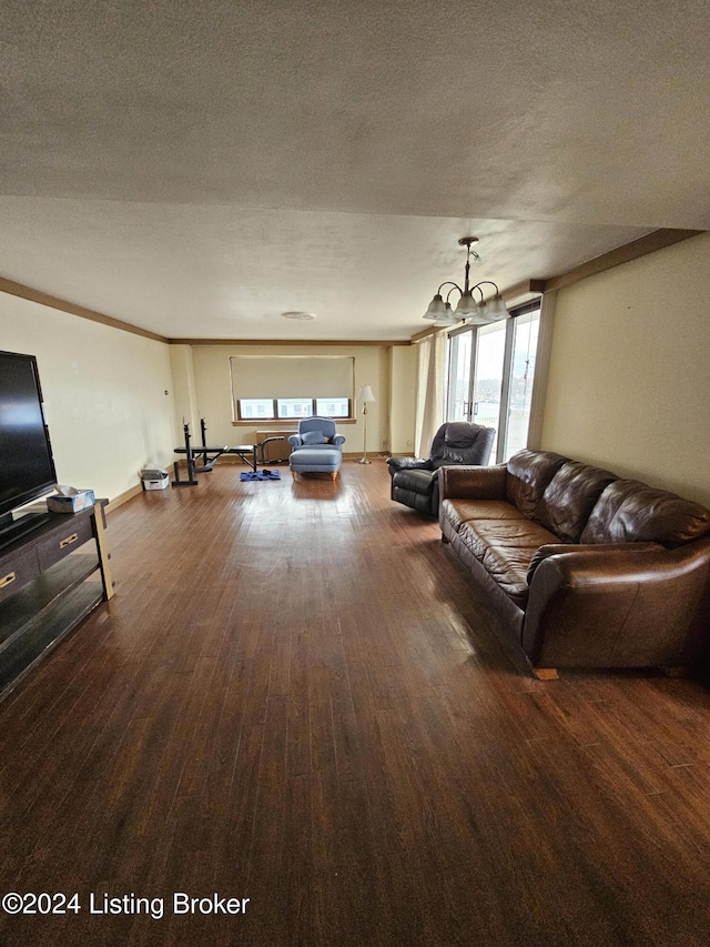 living room featuring a chandelier, hardwood / wood-style floors, a textured ceiling, and a wealth of natural light