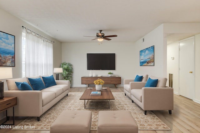 living room with ceiling fan and light hardwood / wood-style floors