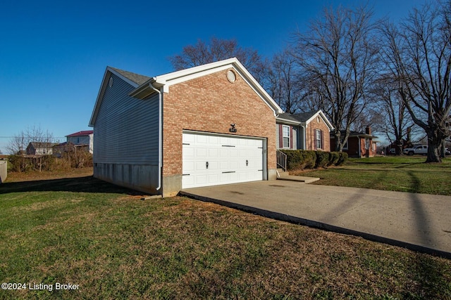 view of side of home featuring driveway, a garage, a lawn, and brick siding