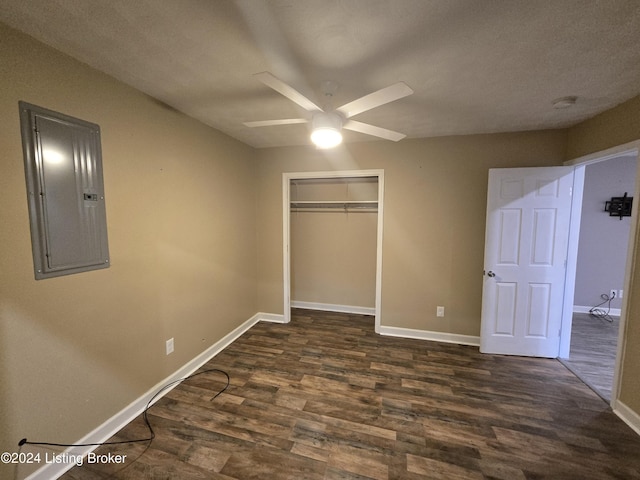 unfurnished bedroom with ceiling fan, dark hardwood / wood-style floors, electric panel, a textured ceiling, and a closet