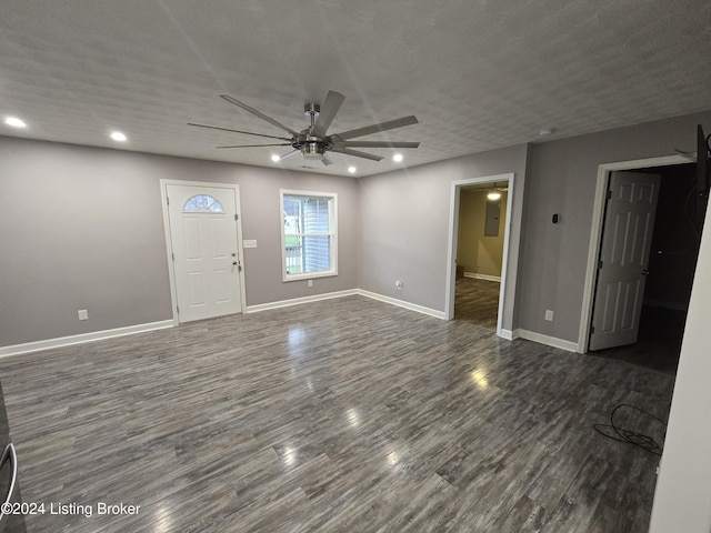 entryway featuring ceiling fan, dark wood-type flooring, and a textured ceiling