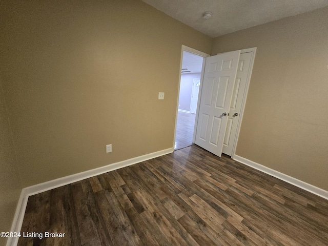 spare room with dark hardwood / wood-style floors