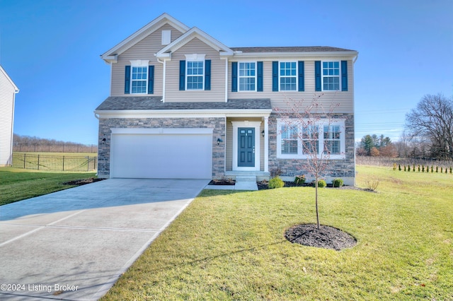 view of front of house featuring a garage and a front lawn