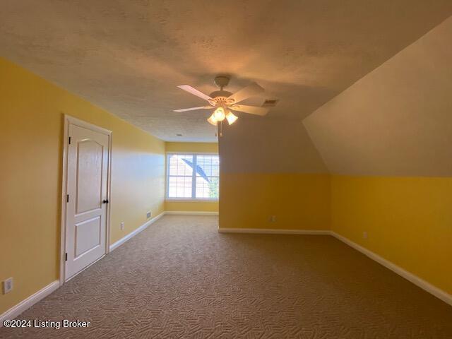 bonus room featuring carpet flooring, ceiling fan, and vaulted ceiling