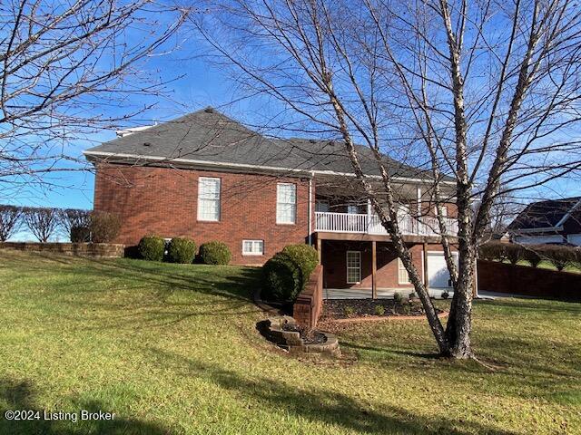 back of house with a lawn and a wooden deck