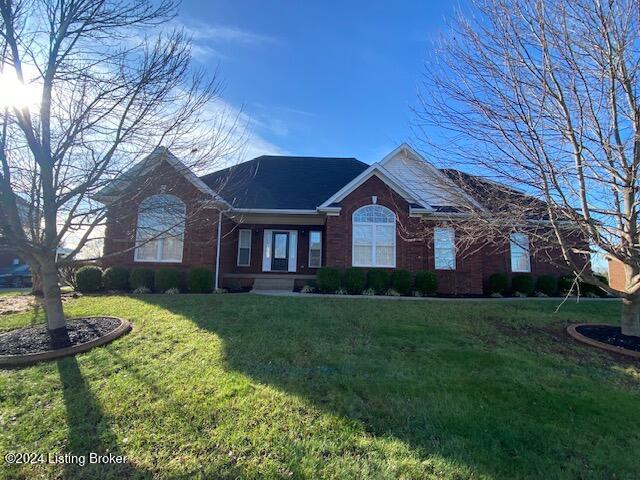 ranch-style home with a front lawn