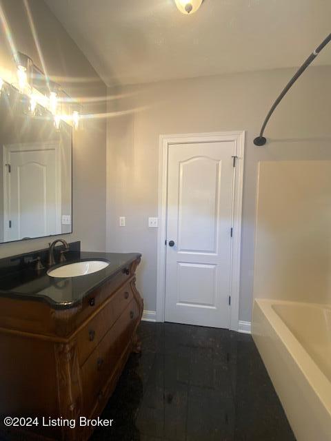 bathroom featuring tile patterned flooring, vanity, and shower / bath combination