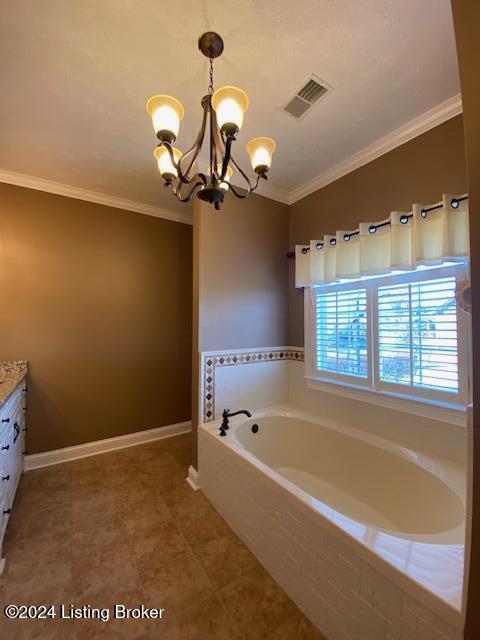 bathroom featuring ornamental molding, vanity, tiled bath, and a notable chandelier