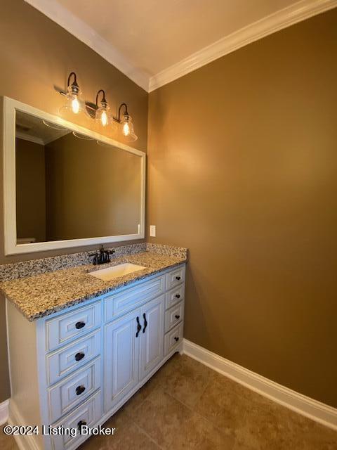 bathroom with tile patterned floors, vanity, and crown molding