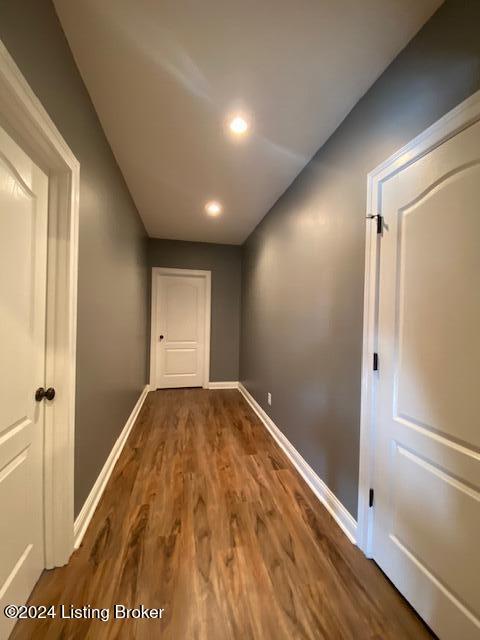 hallway with wood-type flooring