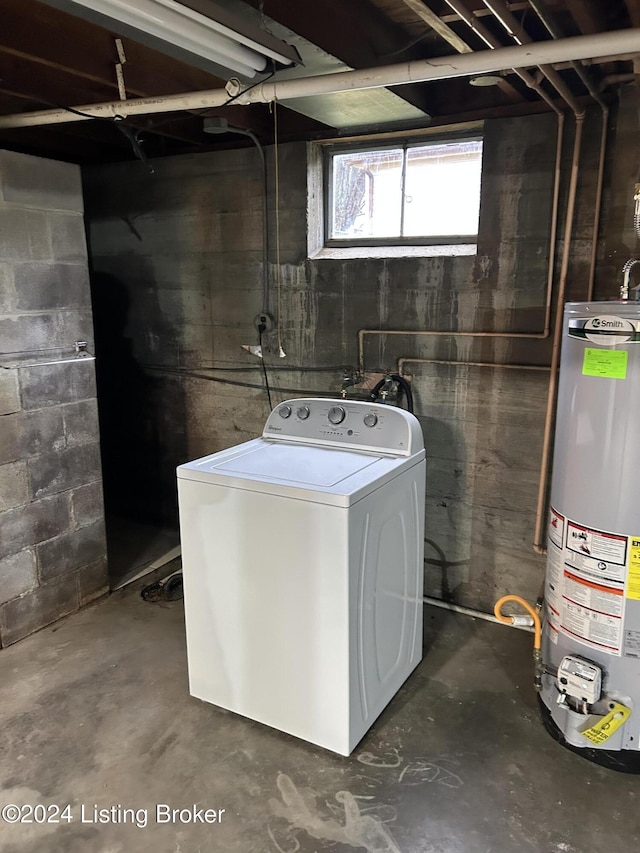 clothes washing area with gas water heater and washer / clothes dryer