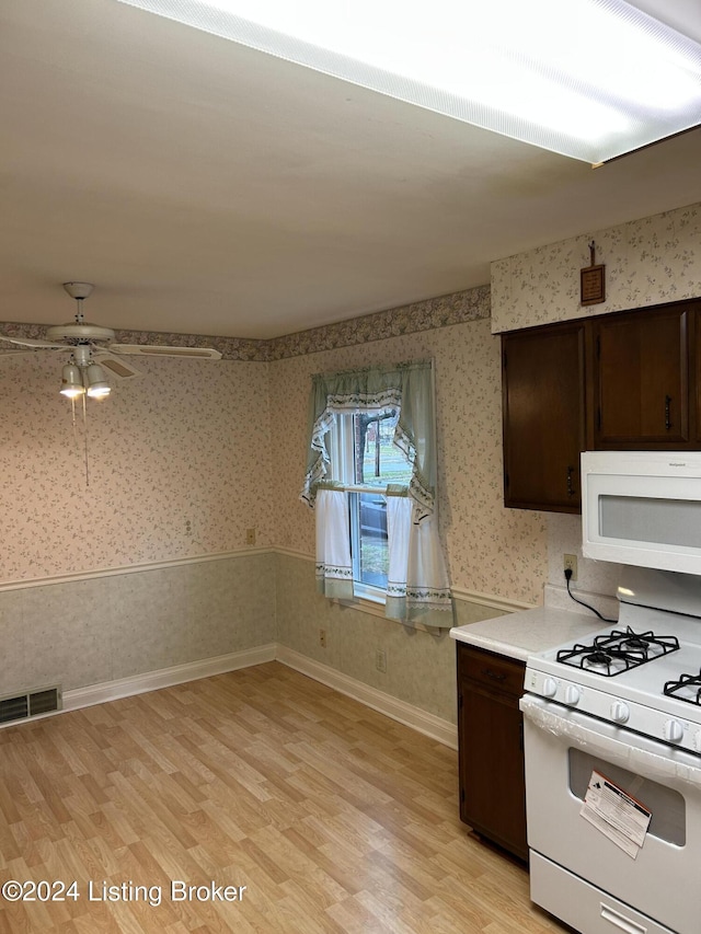 kitchen featuring white appliances, light hardwood / wood-style floors, dark brown cabinetry, and ceiling fan